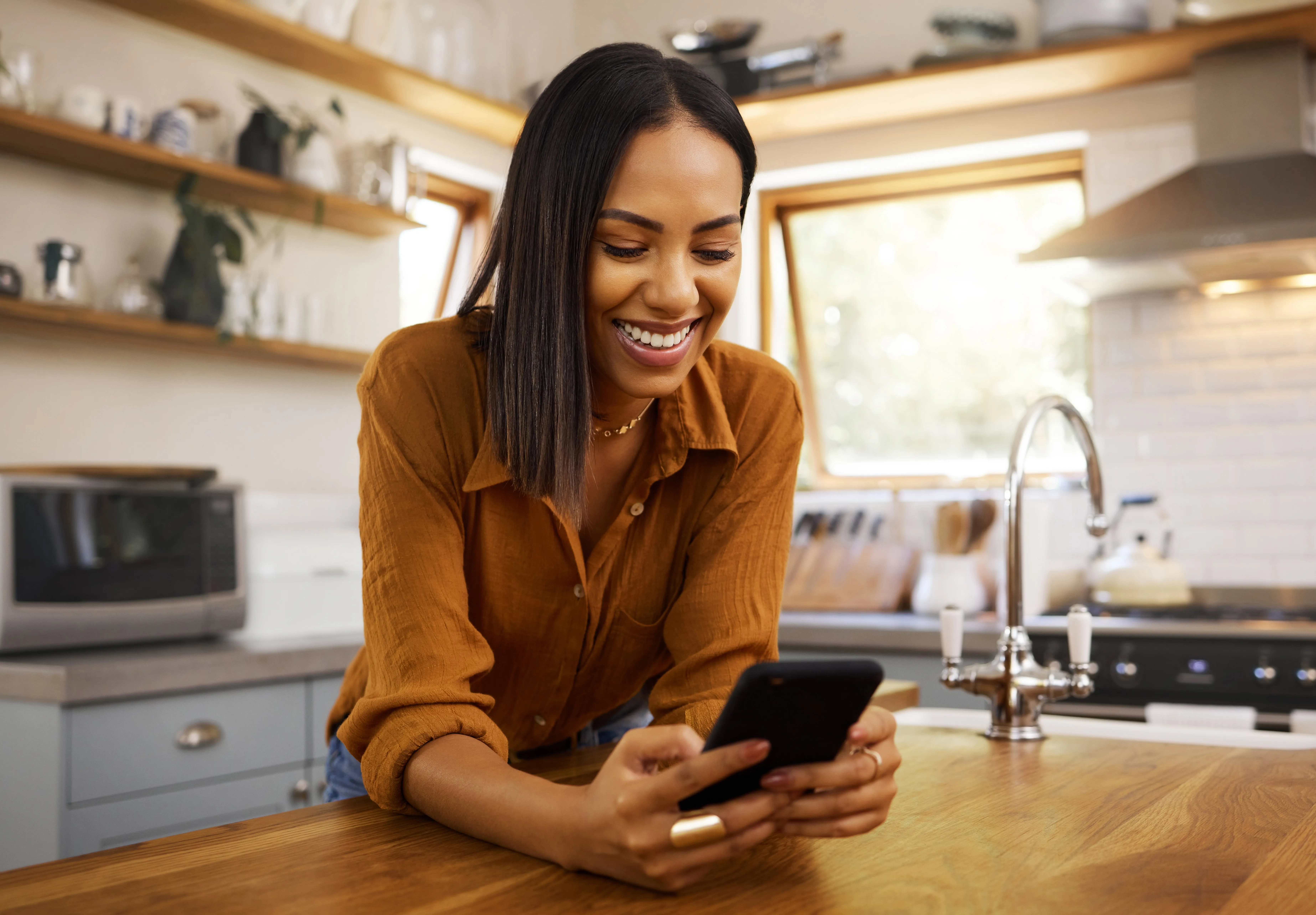 Lady leaning over counter with phone