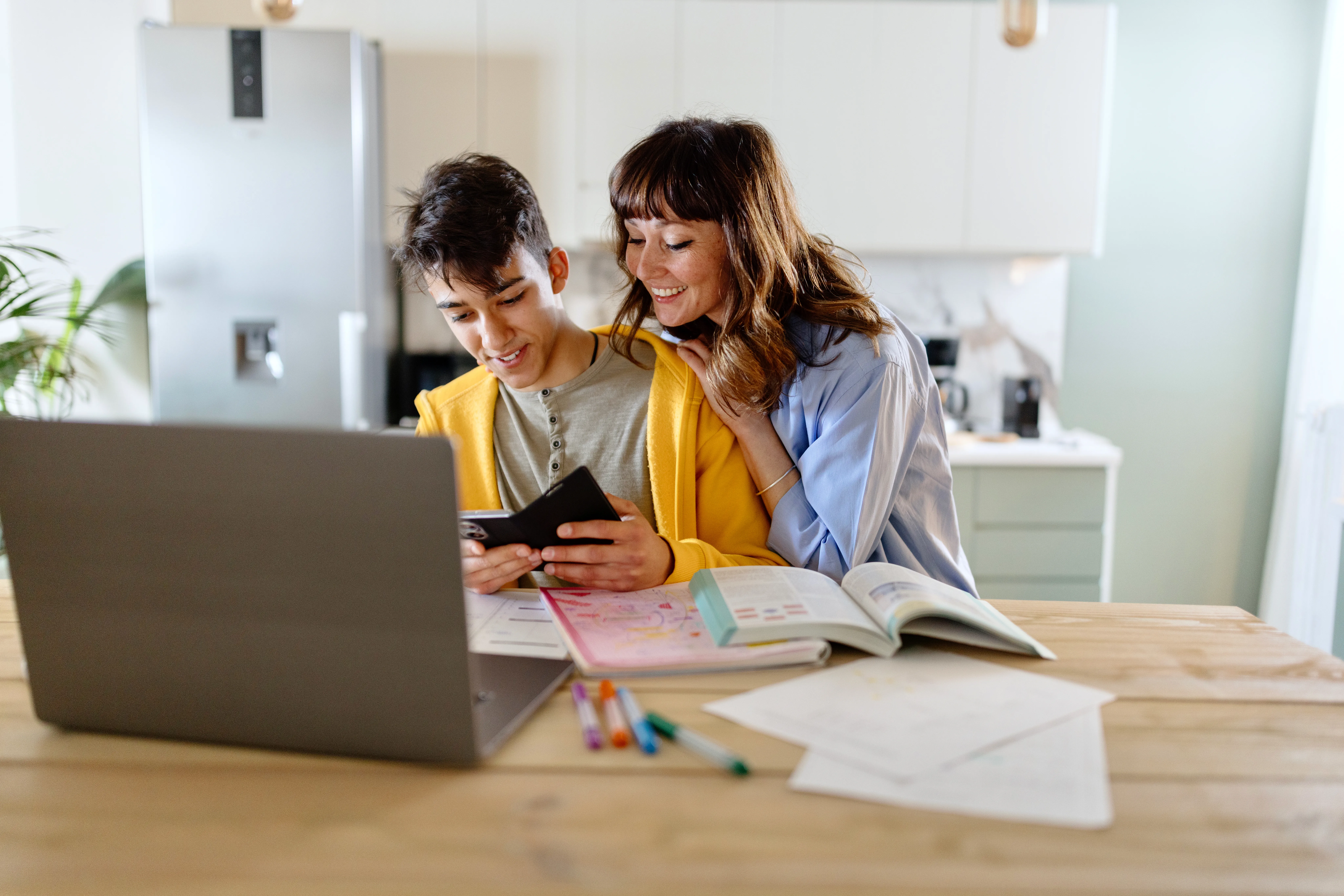 mother and son looking at bank account