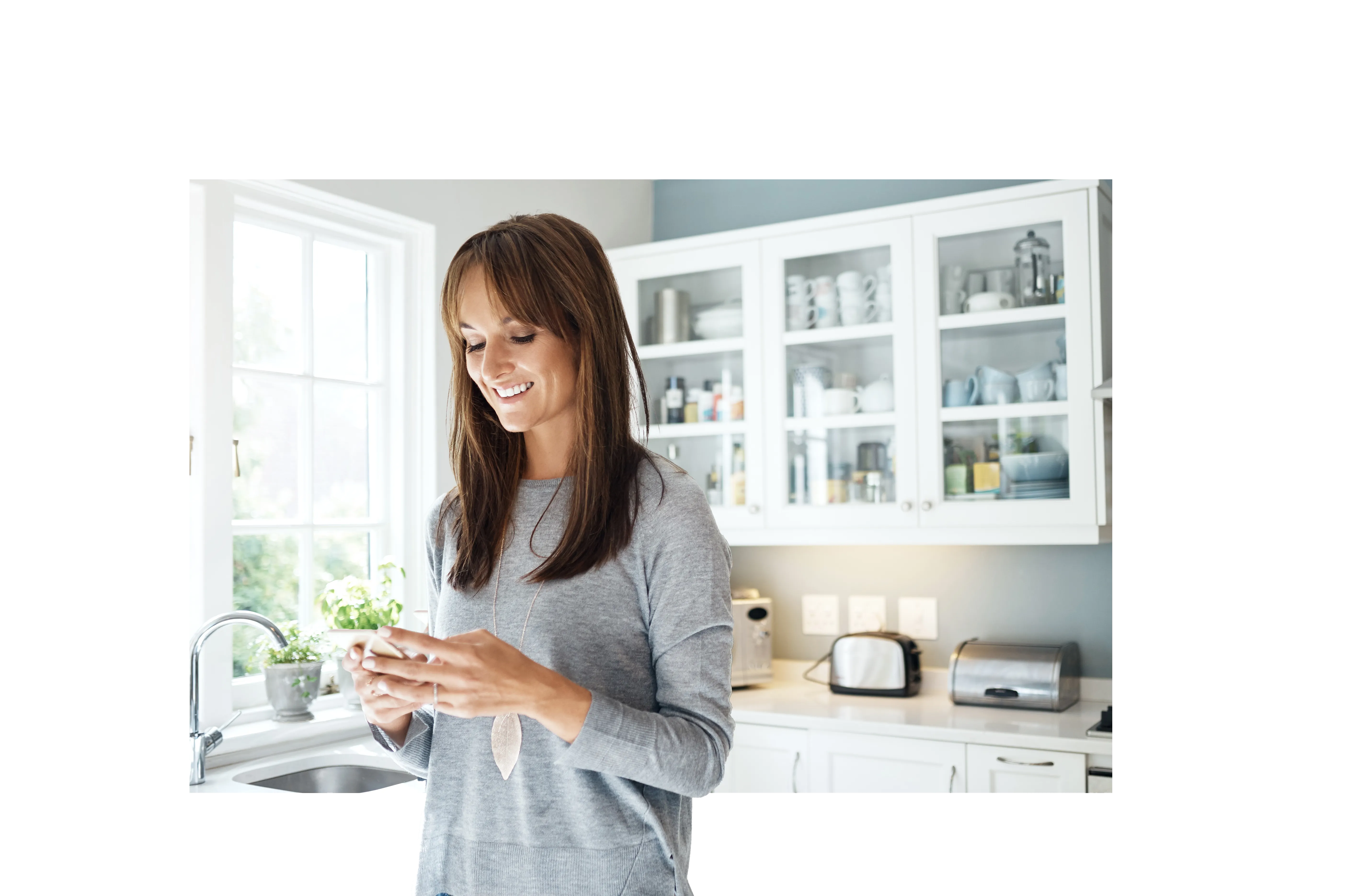 Lady on phone in kitchen