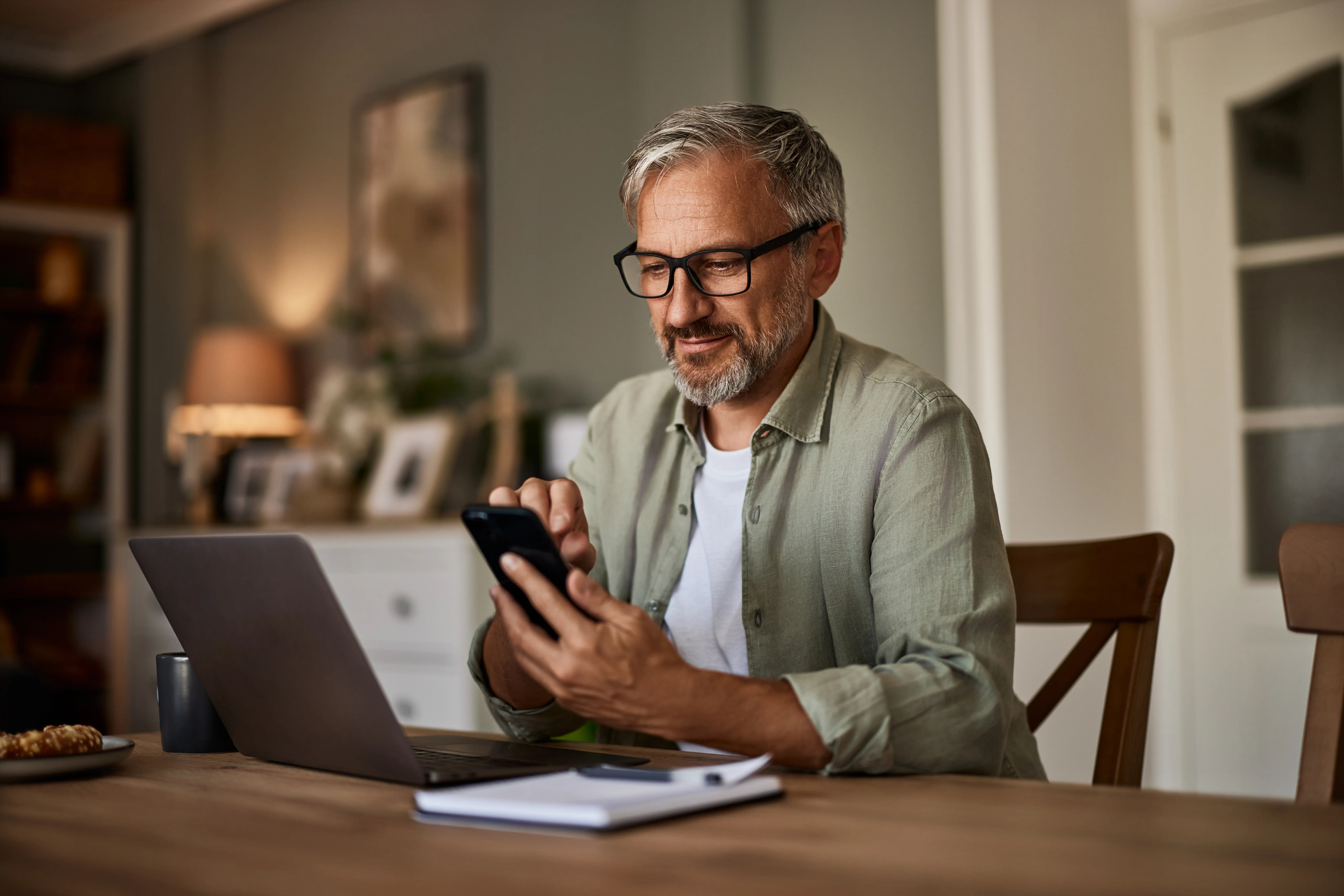 Man with beard on laptop and phone